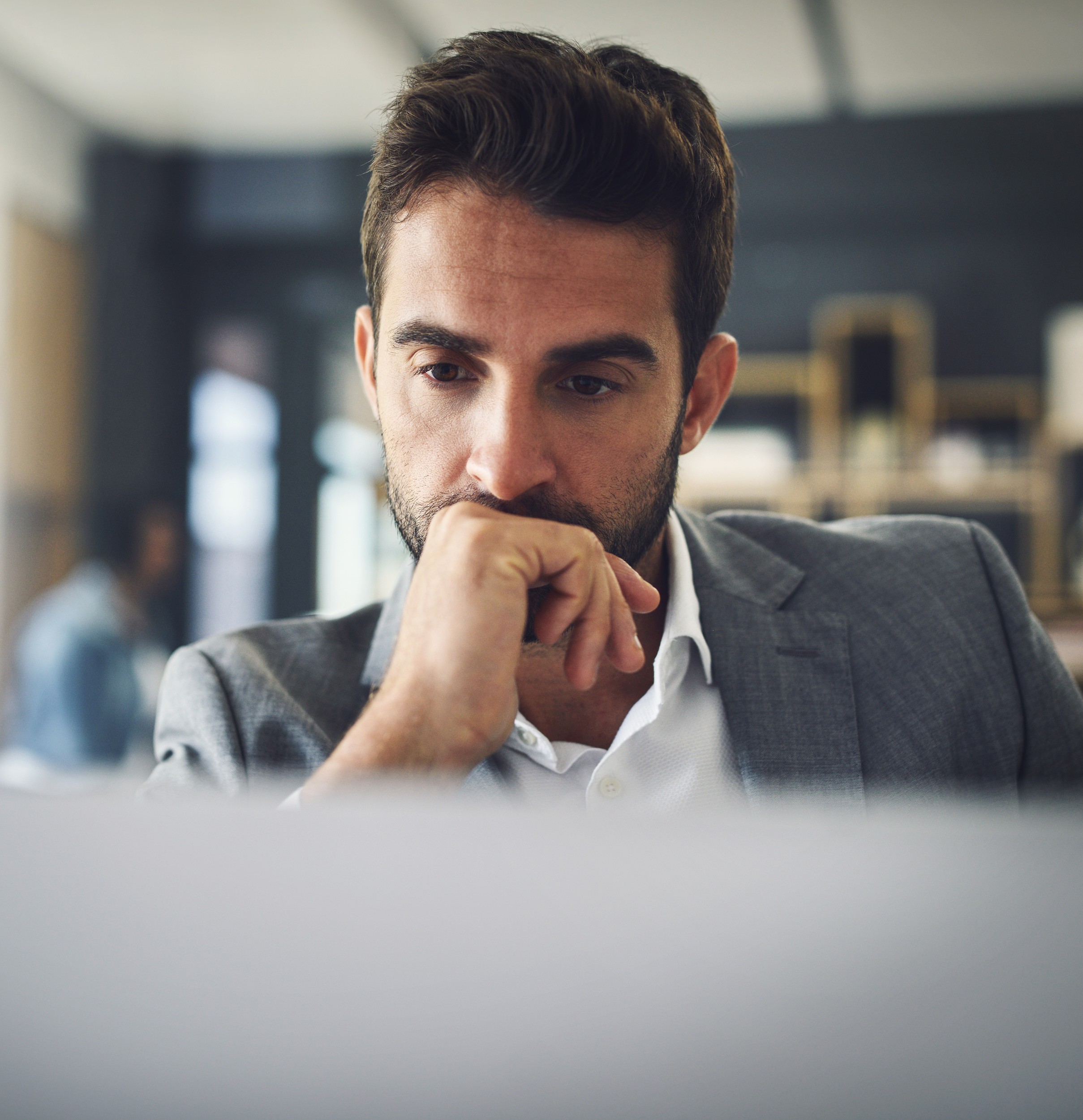 he is big thinker shot focused young businessman working his laptop while contemplating inside office